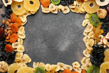 Frame made of assorted dried fruits on grey background