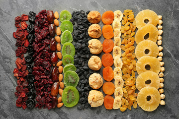 Assortment of tasty dried fruits on grey background