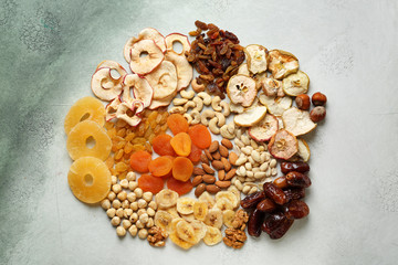 Assortment of tasty dried fruits and nuts on light background