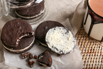 Tasty chocolate cookies on wicker tray, closeup