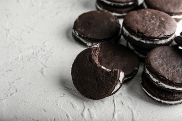 Tasty chocolate cookies on white textured background