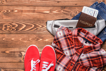 Female clothes with documents on wooden background