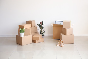 Moving boxes with belongings in empty room