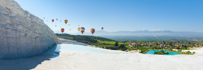 Panoramic collage with hot air ballons flying above snowy white Pamukkale in Turkey