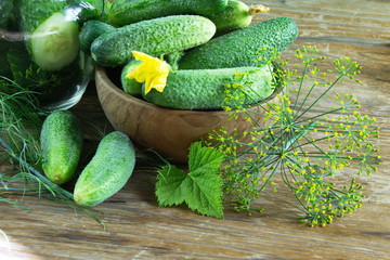 fresh crop of cucumbers gherkins on a retro wooden table surface