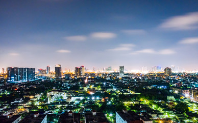 Fototapeta na wymiar Cityscape from high rise building at night with skyline and clouds. skyscraper in metropolis town with beautiful neon light Bangkok Thailand.
