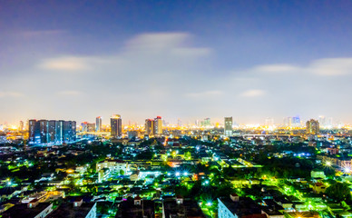 Obraz premium Cityscape from high rise building at night with skyline and clouds. skyscraper in metropolis town with beautiful neon light Bangkok Thailand.