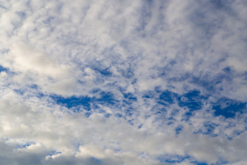 Clouds against the blue sky as a background