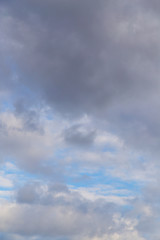 Naklejka na ściany i meble Clouds against the blue sky as a background