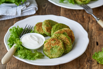 Broccoli cutlets with sour cream and lettuce leaves 