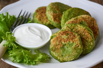 Broccoli cutlets with sour cream and lettuce leaves 