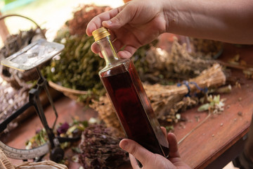 potion bottle in hand of herbalist