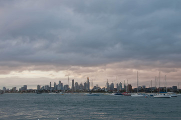 Fototapeta premium Wide angle evening scene of skyscrapers horizon with ocean and tall office and residential towers in Melbourne Australia