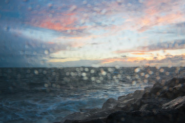 Obraz premium Dramatic splashing ocean wave in the evening with twilight sky in Winter at breakwater at St Kilda pier in Melbourne Australia