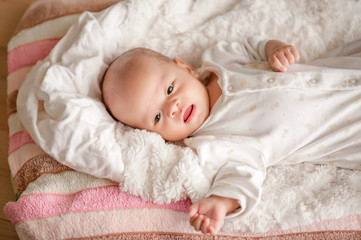 Cute baby boy in a white light bedroom Newborn baby is cute. In bedding for children born - images