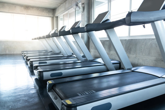 Treadmill at panoramic window in gym