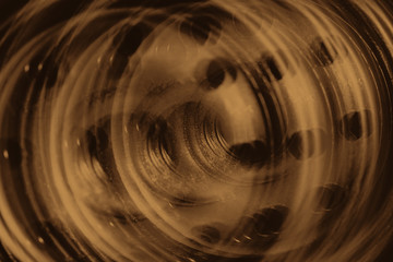 Monochrome multi exposition background of oil filter close up. Artwork from auto part in macro photography. Sepia tones.