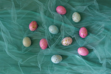 Colorful Easter eggs in a turquoise veil