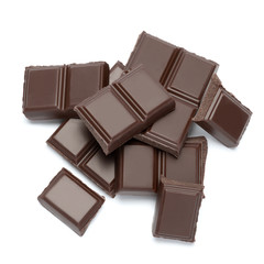 Dark organic chocolate pieces isolated on white background