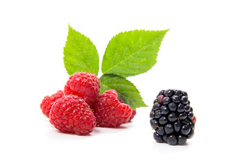 Ripe raspberries with leaf and blackberry isolated on white background.