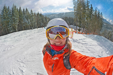 Fototapeta na wymiar Happy woman taking selfie on winter in Carpathian Mountains, Bukovel , Ukraine