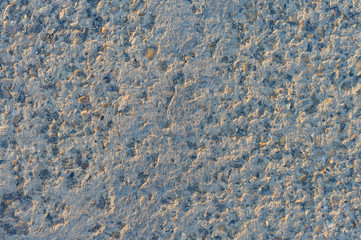 Designer background for interiors of small stone. Stone surface texture close-up.