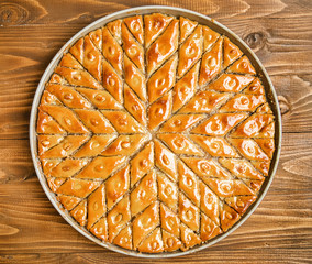 Baklava with nuts on a wooden background. Selective focus.