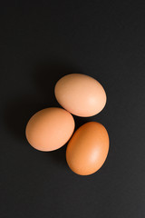 Eggs at black background top view. Copy space for text concept.