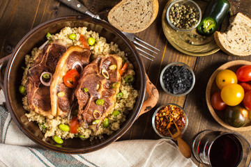Homemade Roasted Lamb Loin Chops with Couscous and Soybean in Rustic Clay Dish
