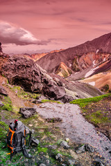 View of colorful rhyolite volcanic mountains Landmannalaugar and a hiking backpack and poles in Iceland