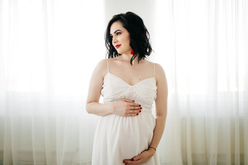 Fototapeta premium Portrait of a elegant beautiful pregnant woman
