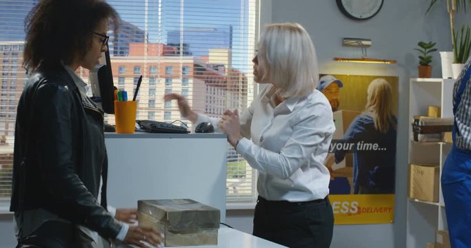 Woman sending a package in a delivery center