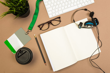 office desk table with  notebook keyboard notebook badge  headphones coffee and glasses Mock up...