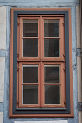 old wooden red and blue window of an half-timbered house