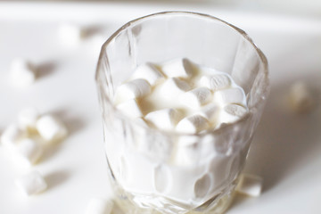 Fototapeta na wymiar marshmallow in a glass of milk. marshmallows on a white background
