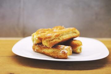 eclairs cakes lie on a white plate.  sweet cakes eclairs