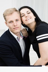 Young attractive business couple in love posing together.