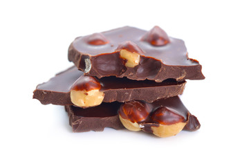 Dark chocolate with hazelnuts. Isolated on white background