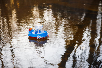 Children's boat blue goes on the golden water