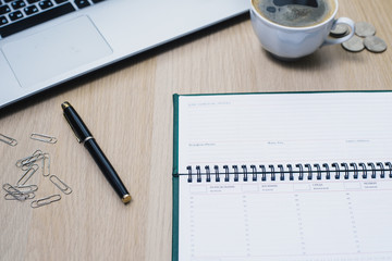 background under the tree with laptop, smartphone and other accessories with a Cup of coffee.