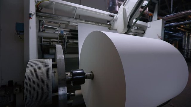 Large roll of paper for the production of wallpaper, a modern factory for the production of wallpaper