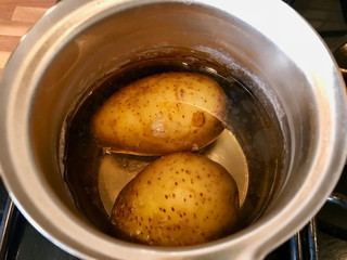 Cooking Potatoes in Boiling Water with Metal Pot.