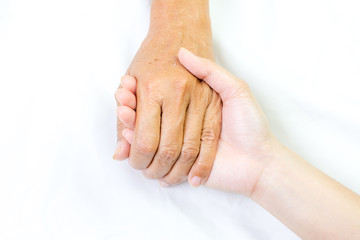 Fototapeta premium Asian senior and asian young holding hands.