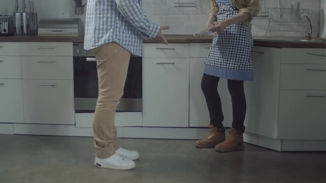 Close-up of plate falling on floor and breaking into small pieces during domestic quarrel between jealous husband and offended wife. How not to glue broken plate so not to connect breaking up couple.