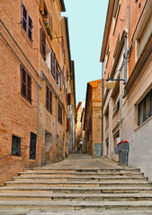 Stone path on streets in Historical center of Macerata with people, old buildings and architecture, Marche, Italy