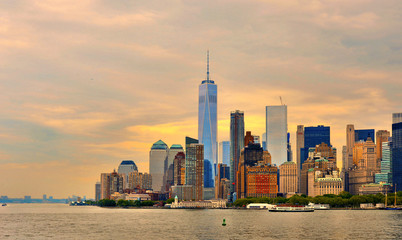  Downtown Manhattan modern skyline with skyscrapers seen from Ellis Island Ferry, panoramic view