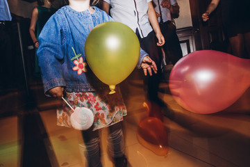 child playing with balloons at party disco at wedding ceremony reception