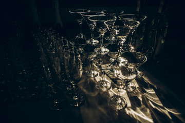 empty glasses of martini and champagne on table at wedding reception, alcohol bar, catering in...
