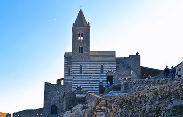 San Pietro church, Lord Byron Natural park in Portovenere village on stone cliff rock and blue sky,...