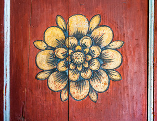 close up view of traditional hand painting on an old wooden door